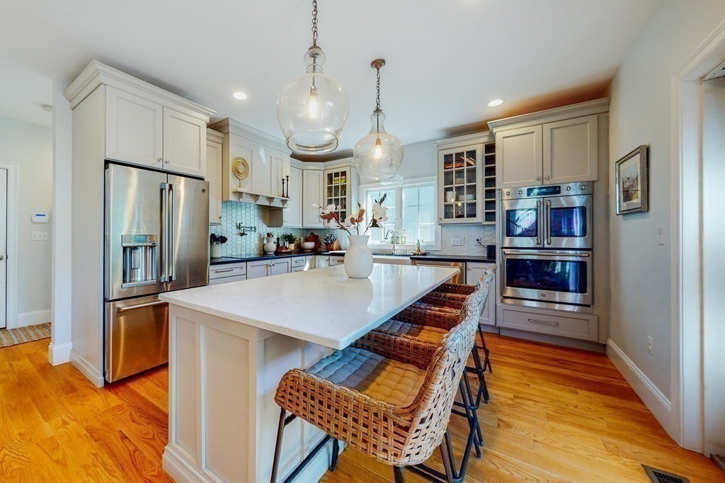 185 Bailey Street Canton, MA 02021 - Photo 7 of 32 a kitchen with stainless steel appliances a refrigerator and a stove top oven