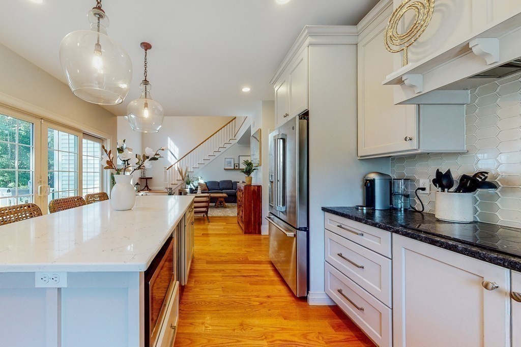 185 Bailey Street Canton, MA 02021 - Photo 8 of 32 a very nice looking kitchen with granite countertop a large counter space and stainless steel appliances