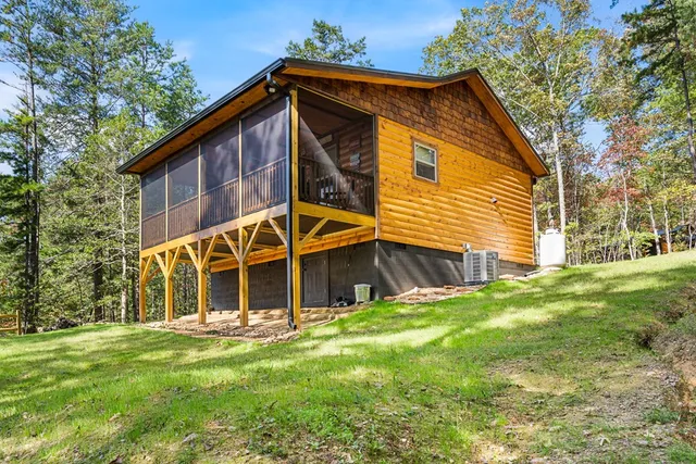 a view of house with backyard
