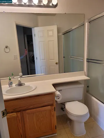 a bathroom with a sink a toilet and mirror
