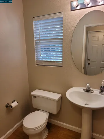 a white toilet sitting next to a bathroom sink