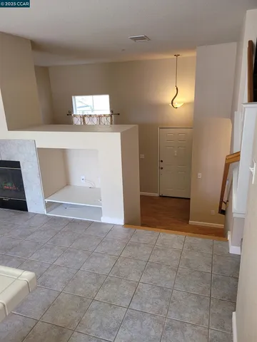 a view of a hallway to rooms and stairs