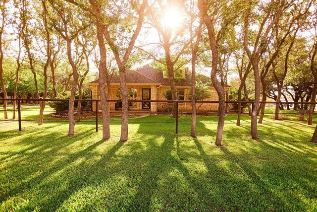 a view of yard with swimming pool and trees