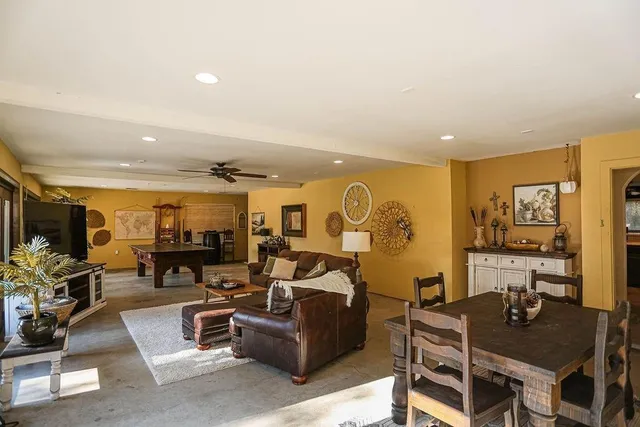 a living room with fireplace furniture and a flat screen tv