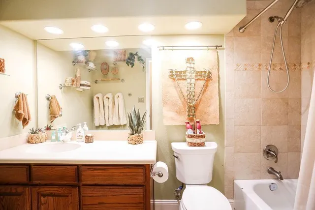 a bathroom with a sink mirror toilet and shower