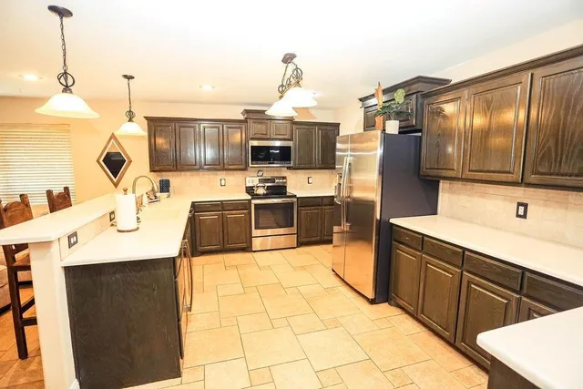 a kitchen with kitchen island granite countertop a sink and counter top space