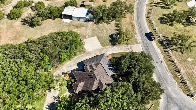 an aerial view of a house with a yard
