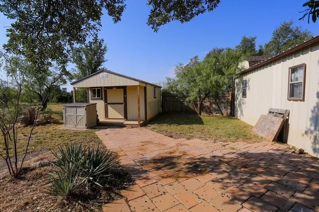 a view of a backyard with a barbeque grill and a fire pit