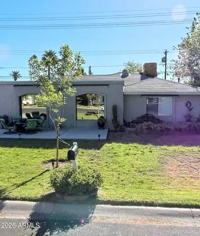 a view of a house with a yard potted plants