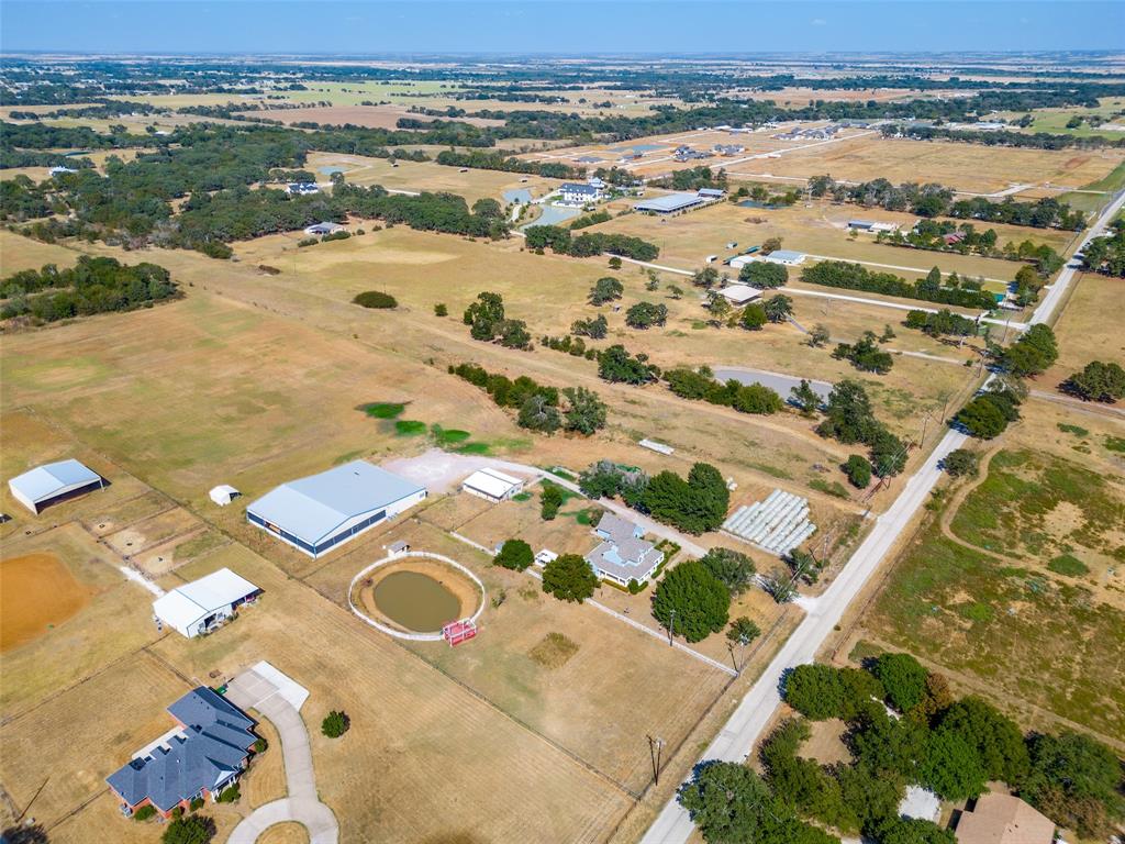 1601 East Blackjack Road East Pilot Point, TX 76258 - Photo 27 of 30 Expansive rural landscape featuring multiple outbuildings, a pond, and residential structures