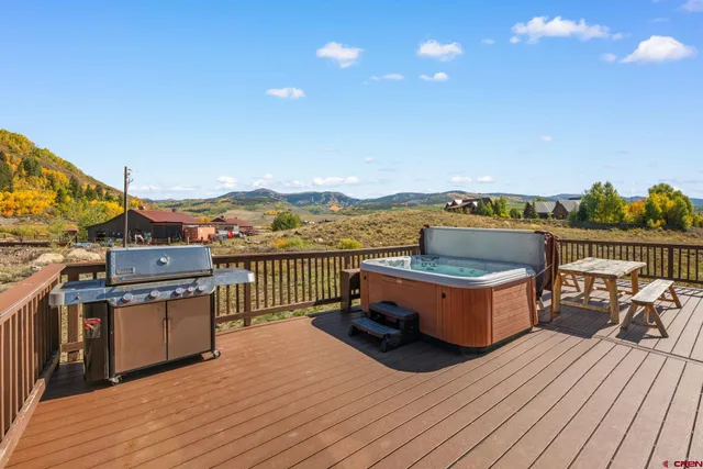 a terrace with outdoor seating and city view