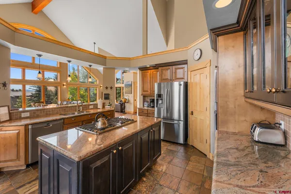 a kitchen with stainless steel appliances granite countertop a stove and a refrigerator