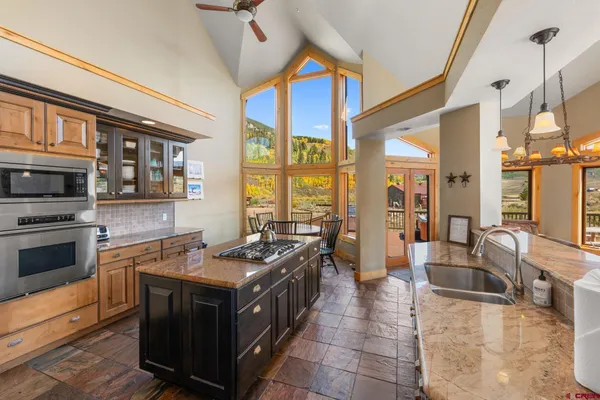 a kitchen with stainless steel appliances granite countertop a stove and a sink