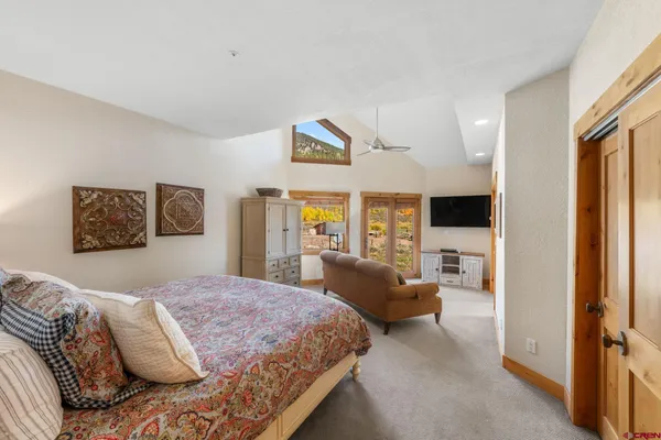 a bedroom with a large bed and a large window