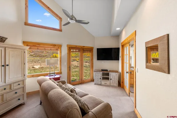 a bedroom with furniture and a flat screen tv
