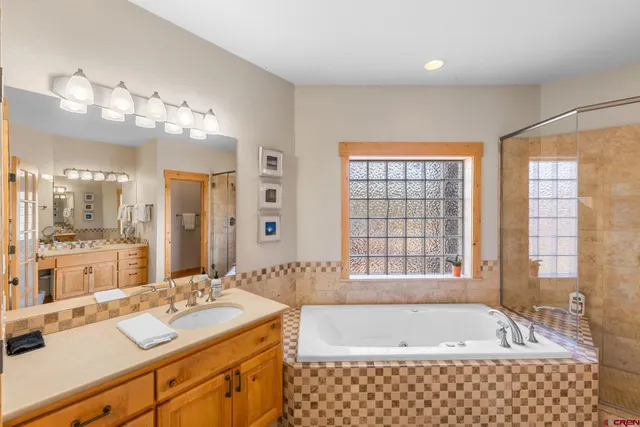 a spacious bathroom with sink shower and bathtub