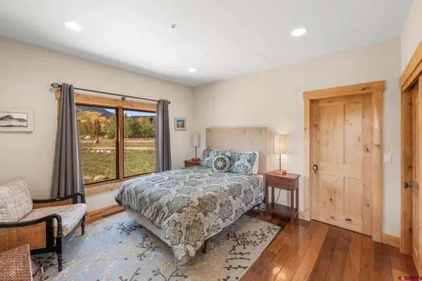 a bedroom with a bed and large window