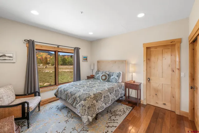 a bedroom with a bed and large window