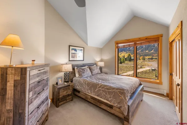 a bedroom with a bed and a lamp next to a window