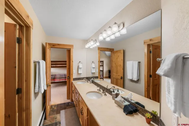 a en suite bathroom with a double vanity sink and a mirror