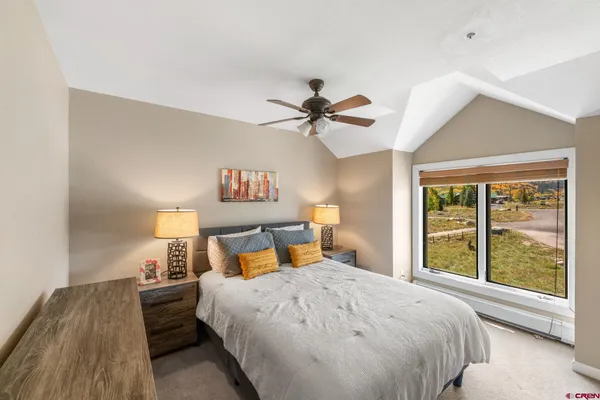 a bedroom with a bed and a large window