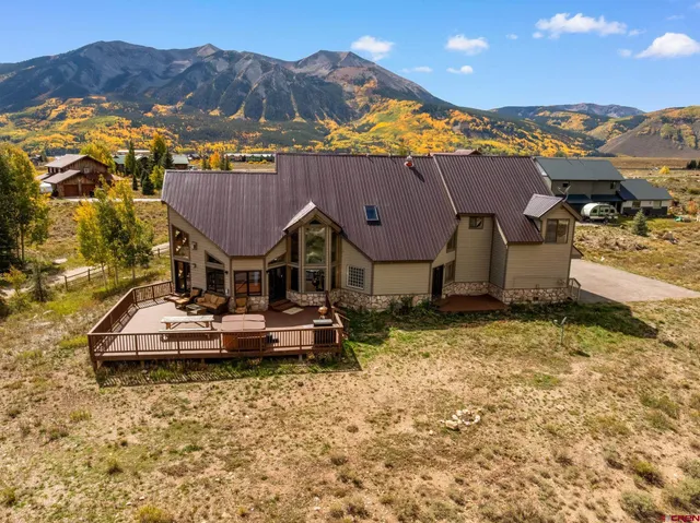 a view of a house with a yard and sitting area