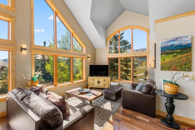 a living room with furniture a fireplace and a large window