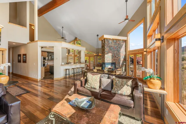 a living room with fireplace furniture and a painting on the wall