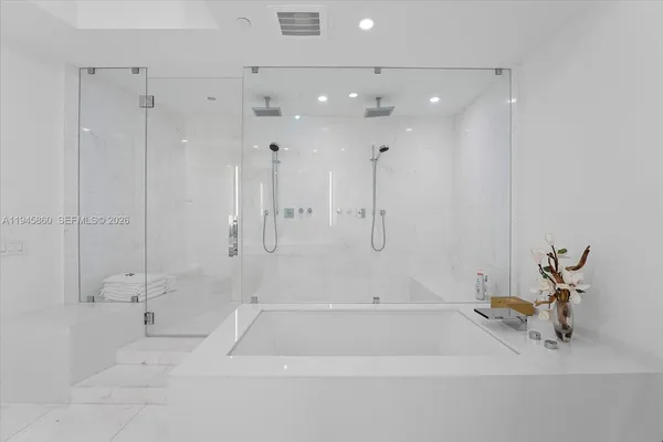 a bedroom with furniture and large window