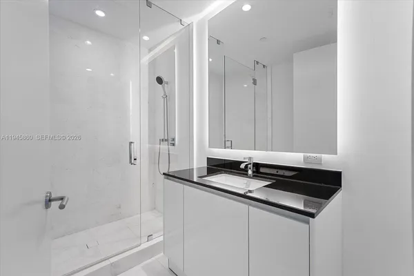 a bedroom with a large bed and a large window