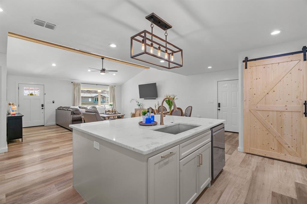 1021 Poe Street Azle, TX 76020 - Photo 18 of 38 a view of a kitchen counter space and wooden floor