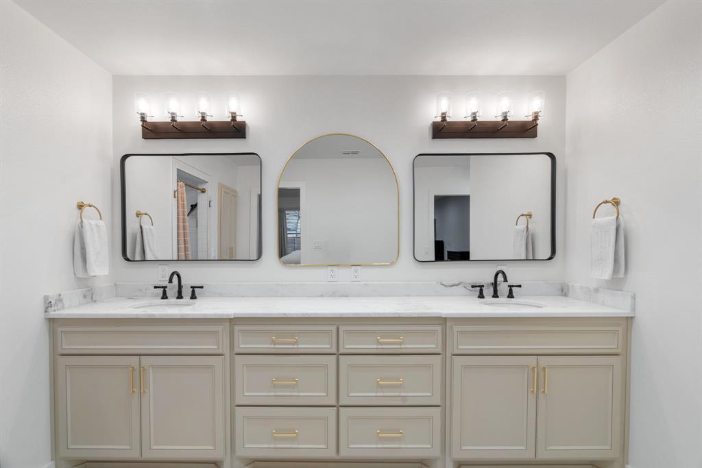 1021 Poe Street Azle, TX 76020 - Photo 22 of 38 a bathroom with double vanity sinks and a mirror