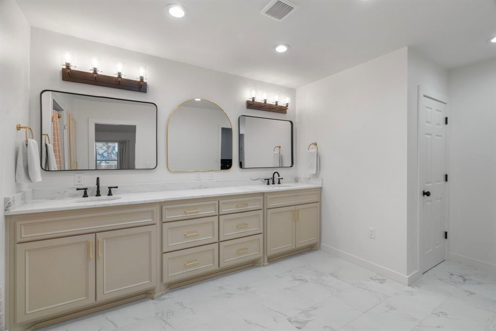 1021 Poe Street Azle, TX 76020 - Photo 23 of 38 a bathroom with double vanity sinks and a mirror