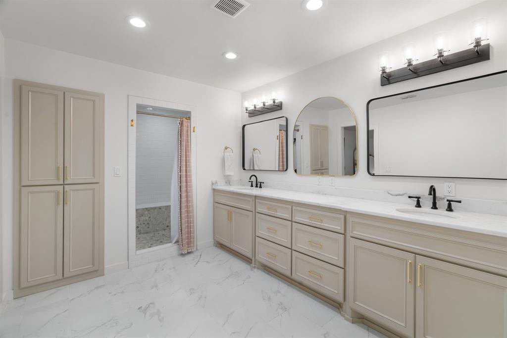 1021 Poe Street Azle, TX 76020 - Photo 24 of 38 a bathroom with double vanity sinks and a mirror