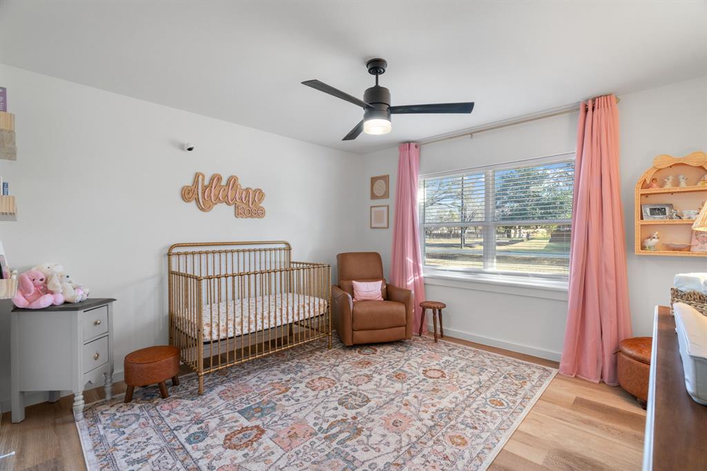 1021 Poe Street Azle, TX 76020 - Photo 30 of 38 a bedroom with a bed and a window