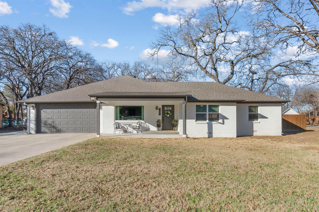 1021 Poe Street Azle, TX 76020 - Photo 3 of 38 a front view of a house with a yard and garage