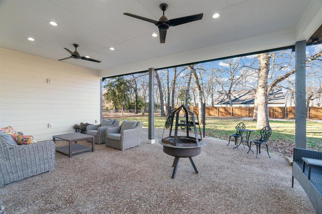 1021 Poe Street Azle, TX 76020 - Photo 34 of 38 a living room with furniture and a floor to ceiling window