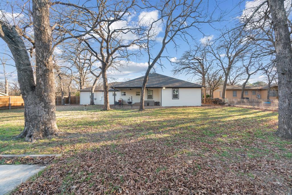 1021 Poe Street Azle, TX 76020 - Photo 36 of 38 a view of a house with a yard and large tree
