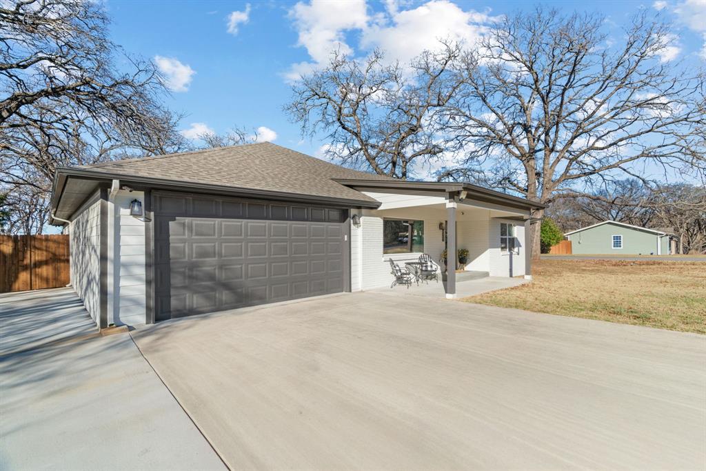 1021 Poe Street Azle, TX 76020 - Photo 4 of 38 a front view of a house with a yard and garage