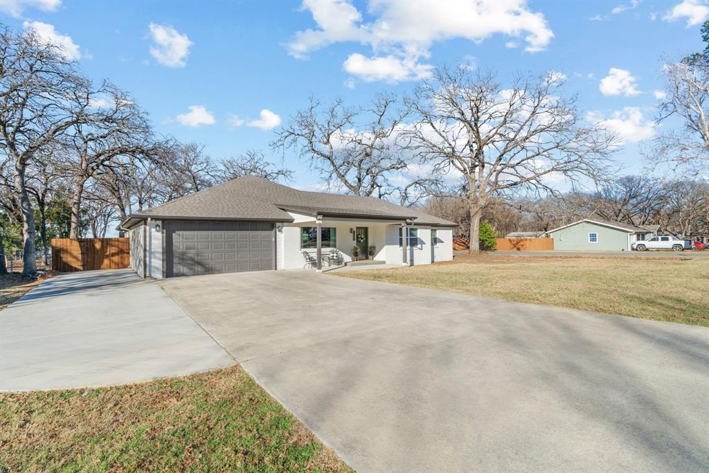 1021 Poe Street Azle, TX 76020 - Photo 5 of 38 a front view of a house with a yard