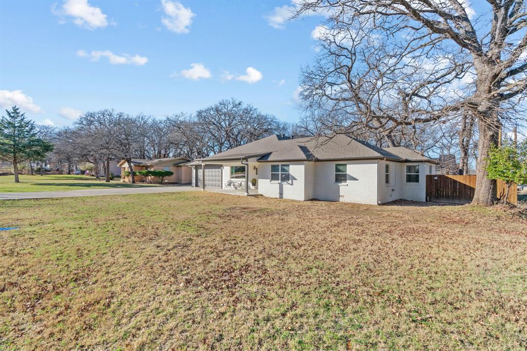 1021 Poe Street Azle, TX 76020 - Photo 6 of 38 a front view of house with yard and trees
