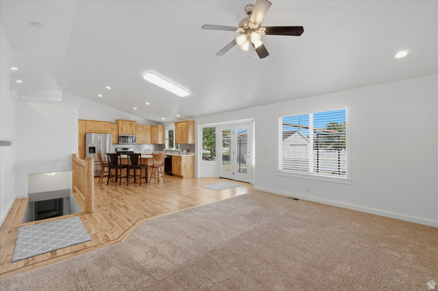 791 East Saddle Road Grantsville, UT 84029 - Photo 16 of 46 Open-concept living area featuring a vaulted ceiling and a ceiling fan