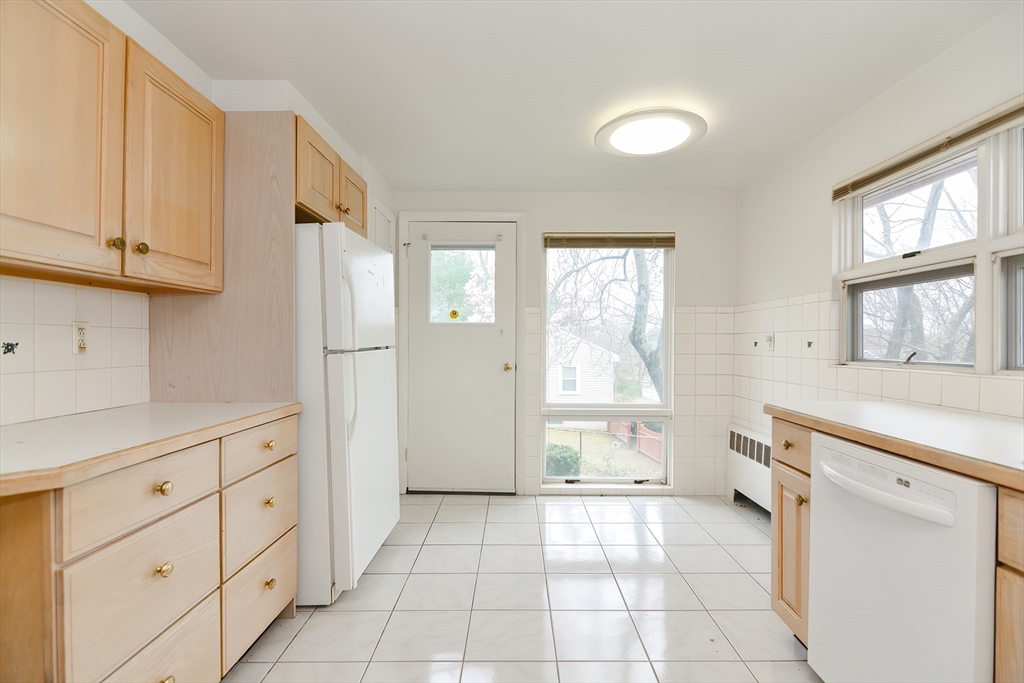 119 Ridge Street Winchester, MA 01890 - Photo 12 of 42 a kitchen with white cabinets and a window
