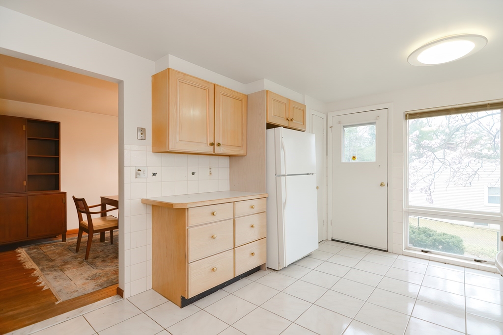119 Ridge Street Winchester, MA 01890 - Photo 9 of 42 a kitchen with white cabinets and window