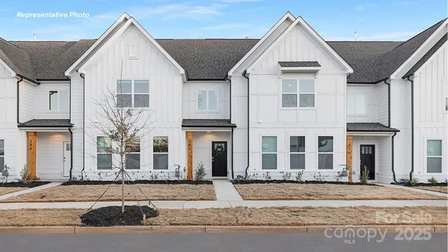 a view of a white house with a sink and yard