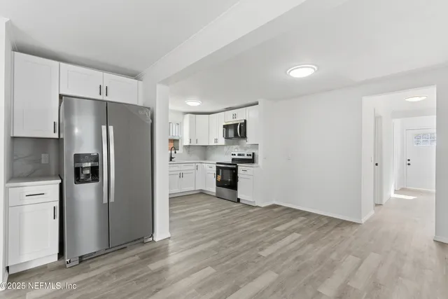 a kitchen with a refrigerator and a sink