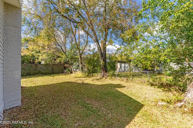 a view of a yard with swimming pool