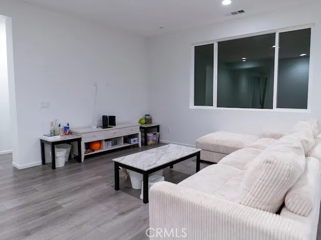 a view of a hallway with wooden floor