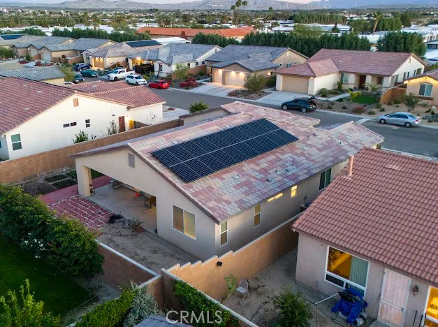 an aerial view of a houses with a city view