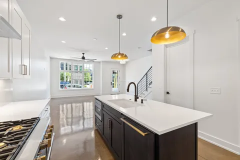 a kitchen with a sink a counter space and a window